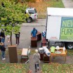 Volunteers delivering furniture to house