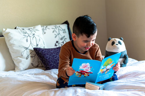 Boy reading in bed