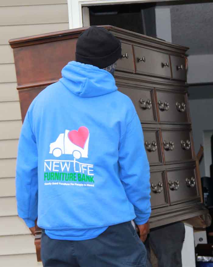 Carry in donated dresser for family in need.