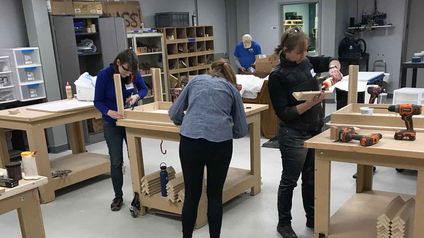 Assembling donated furniture for families in need.