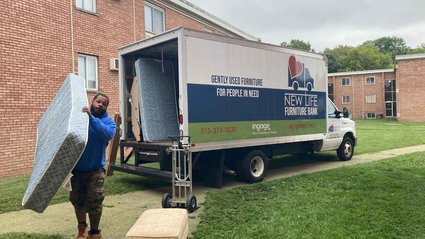 Volunteer unloading donated bed.
