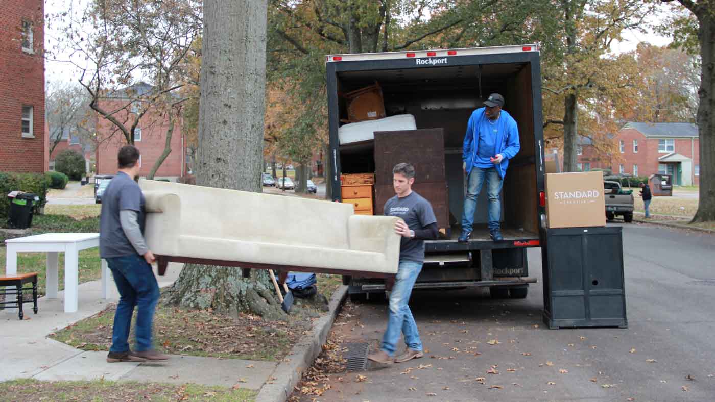 Volunteers and staff collecting furniture donated to families in need.